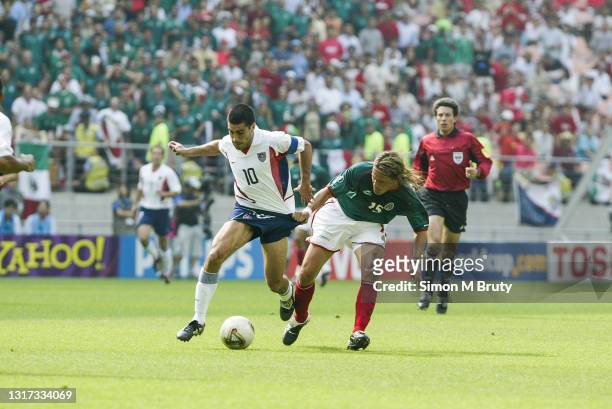 Claudio Reyna of the USA and Luis Hernandez of Mexico in action during the World Cup round of Sixteen match between Mexico and USA at the Jeonju...