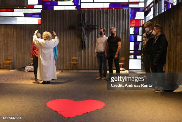 Brigitte Schmidt, a pastoral worker blesses a same-sex couple, as Ralf Michael Berger and Andreas Helfrich look on, at the Catholic St. Johannes...