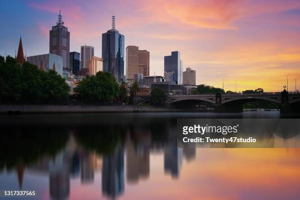 beautiful sunset over melbourne city skyline downtown long exposure photograph - melbourne stock pictures, royalty-free photos & images