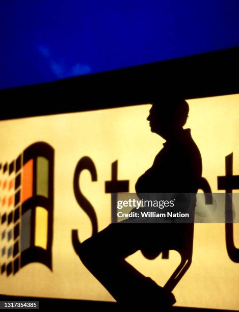 Silhouetted image of American business magnate, software developer, investor, author, and philanthropist Bill Gates launches the Windows 95 software...