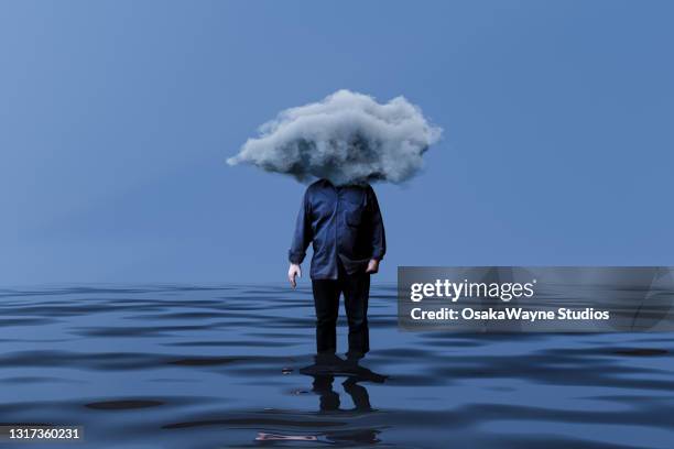 man with head in cloud and wet feet. - thinking man cloud stockfoto's en -beelden