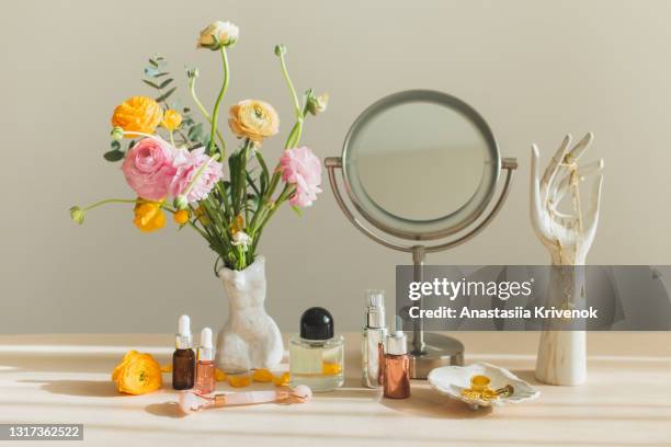 mirror and cosmetic products on female table at home. - soins de beauté photos et images de collection