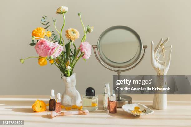 mirror and cosmetic products on female table at home. - cosmetics products stock pictures, royalty-free photos & images