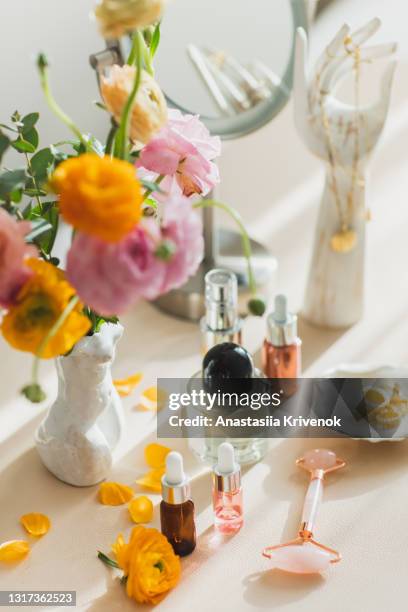 mirror and cosmetic products on female table at home. - perfume stock-fotos und bilder