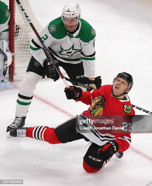 Philipp Kurashev of the Chicago Blackhawks is checked by Jamie Oleksiak of the Dallas Stars at the United Center on May 10, 2021 in Chicago, Illinois.