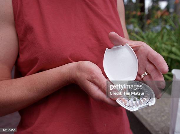 Woman holds prescription contraceptives June 13, 2001 in Seattle, Washington. A federal judge ruled on that Bartell Drug Co., which operates 50 drug...