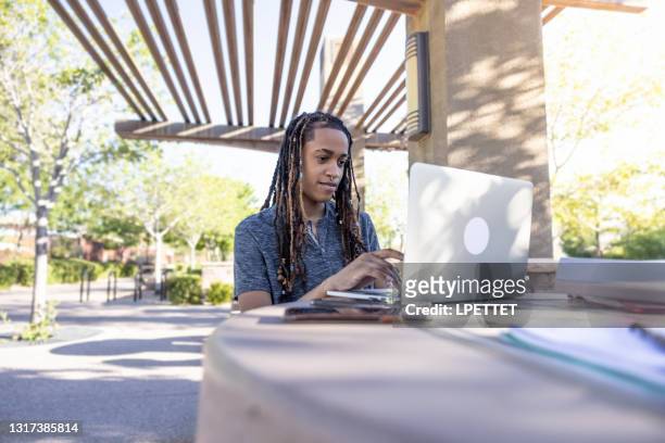 student on the college campus - androgyn stock pictures, royalty-free photos & images