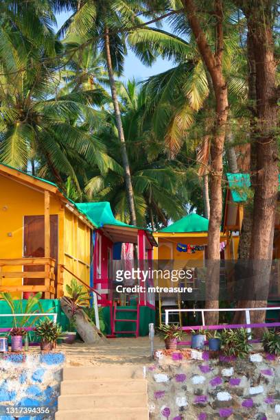 image of palolem beach huts and sea ocean view raised high wooden treehouse beach hut windows overlooking balcony terrace fishing boats, goa beaches, india - goa resort stock pictures, royalty-free photos & images