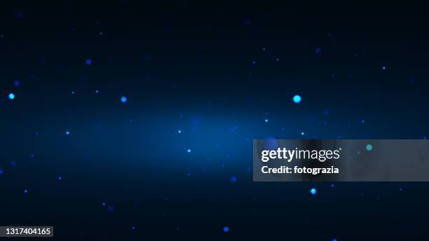 defocused particles against dark blue gradient background - light particles stock pictures, royalty-free photos & images