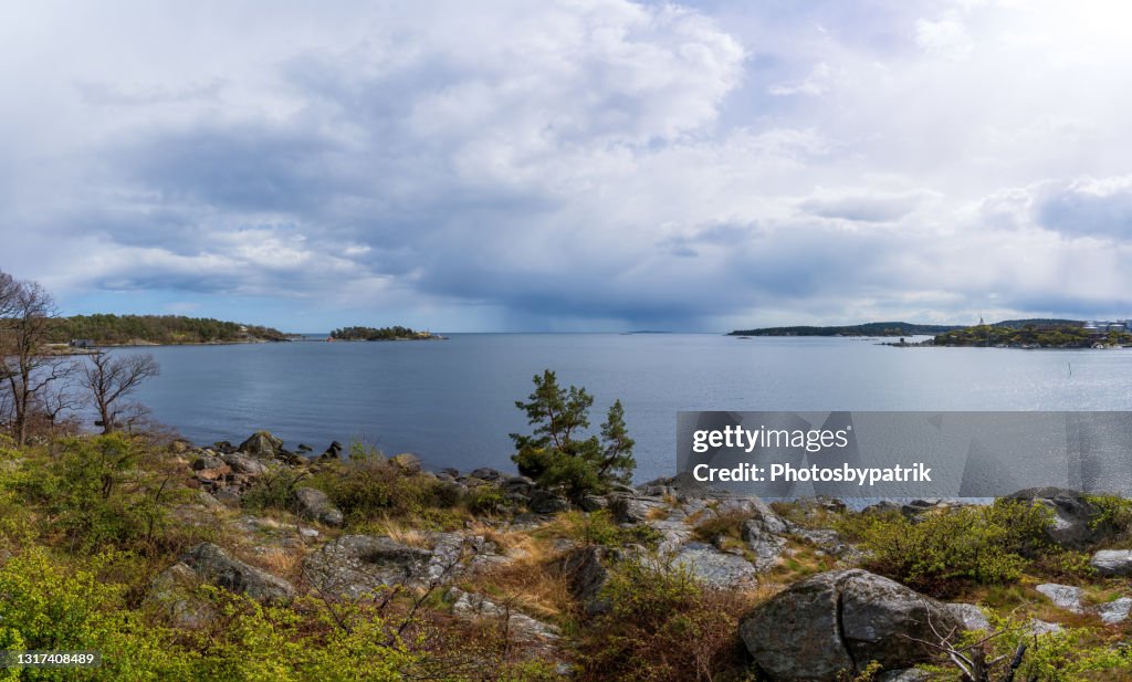 Dramatic spring weather with sun and dark rain clouds over the sea in Karlshamn, Sweden.