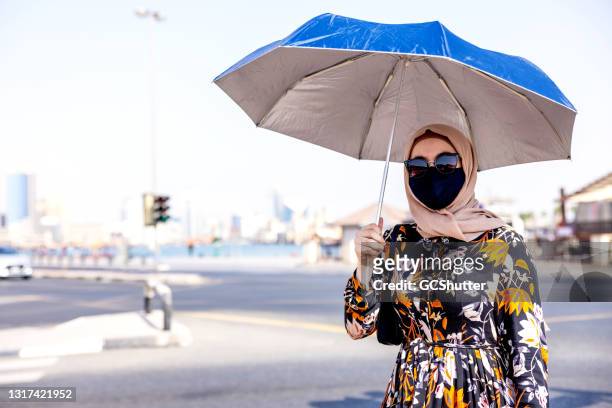 portrait of a middle eastern girl holding umbrella - hot arabic girl stock pictures, royalty-free photos & images