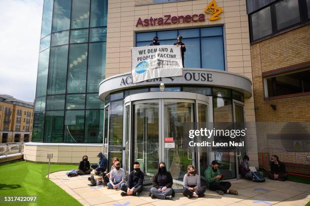 Members of a group called "The People's Vaccine" protest outside the AstraZeneca headquarters as they call for the pharmaceutical company to make the...
