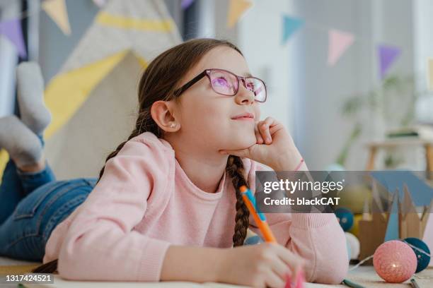 creative little girl is thinking - thinking young stock pictures, royalty-free photos & images