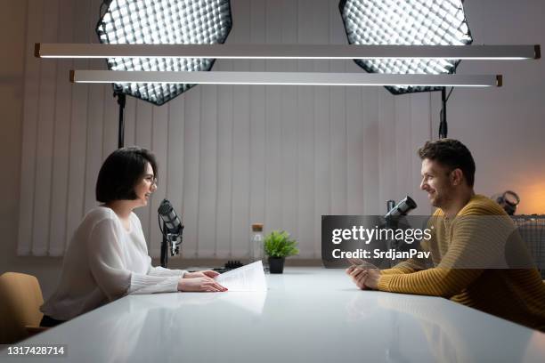 side view of two young commentators on the podcast - radio dj studio stock pictures, royalty-free photos & images