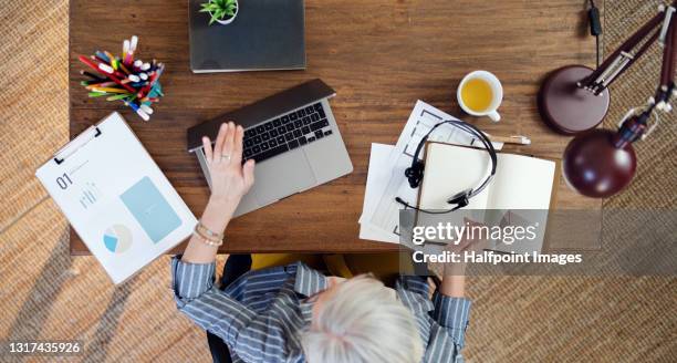 top view of senior businesswoman in home office, closing laptop after work. - working on laptop in train top view stock pictures, royalty-free photos & images