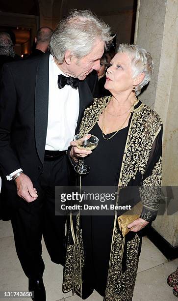 David Mills and Dame Judi Dench attend the Harper's Bazaar Women Of The Year Awards in association with Estee Lauder and NET-A-PORTER at Claridges...