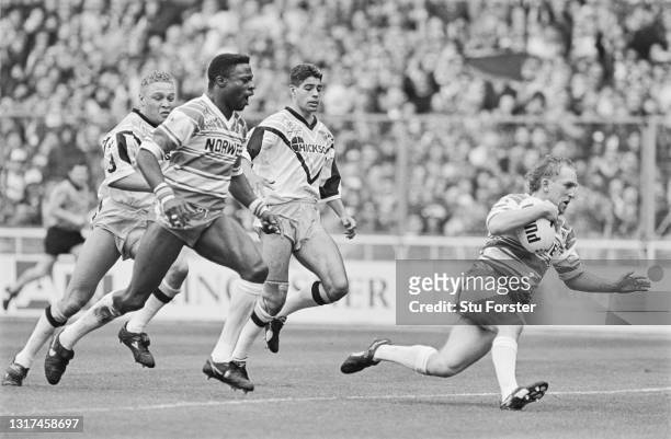 Wigan stand off Shaun Edwards crosses the line to score a try as wing Martin Offiah celebrates during The 1992 Challenge Cup Final between Wigan and...