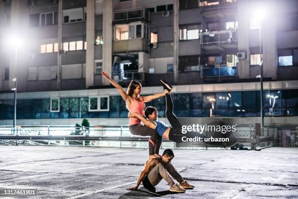 acroyoga outdoors - acroyoga stock pictures, royalty-free photos & images