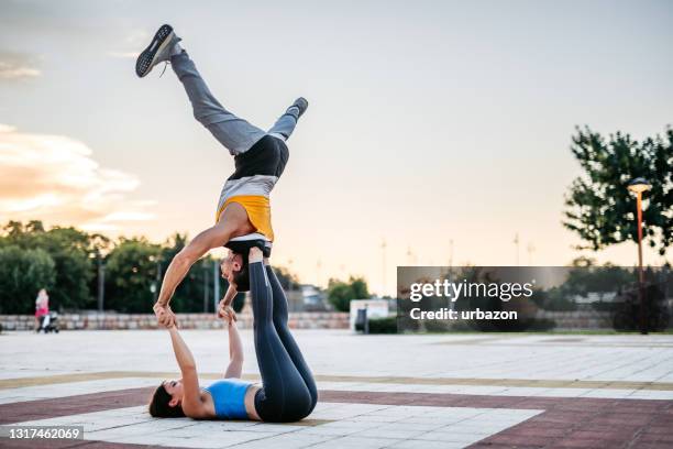 couple doing acroyoga - acroyoga stock pictures, royalty-free photos & images