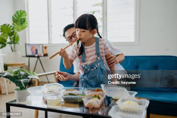 asian man having take out food with his daughter - asian food stock pictures, royalty-free photos & images