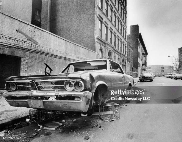An abandoned car sits on East 146th Street in the South Bronx, New York, on March 31, 1972.