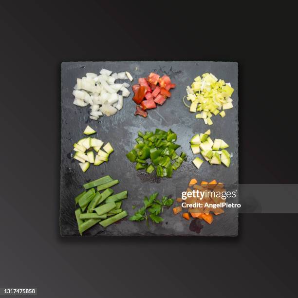 multicolored mosaic of small amounts of vegetables before being cooked. - carrots white background stockfoto's en -beelden