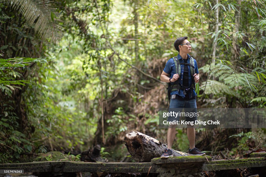 Asian Chinese mid adult man going for hiking in the weekend