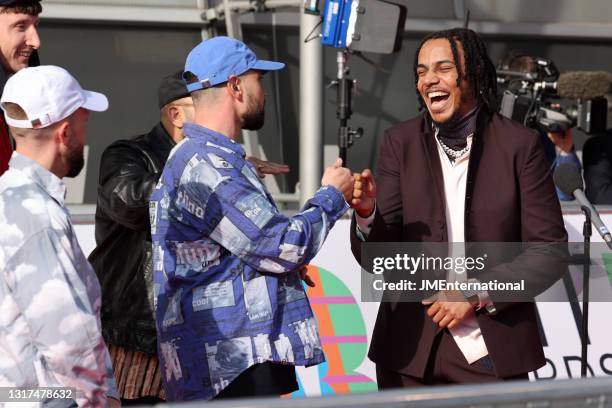 Tracey bumps fists with Allan Mustafa of Kurupt FM as they arrive at The BRIT Awards 2021 at The O2 Arena on May 11, 2021 in London, England.