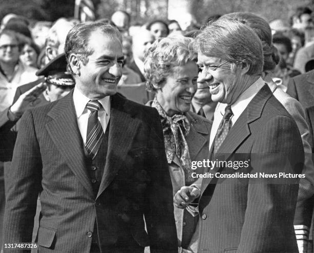 View of the Shah of Iran Mohammed Reza Pahlavi and US President Jimmy Carter as they share a smile during a State Visit on the South Lawn of the...