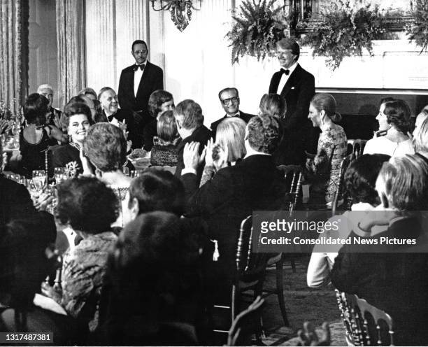 President Jimmy Carter offers a toast to the Shah of Iran Mohammed Reza Pahlavi during a State Dinner in the latter's honor in the State Dining Room...