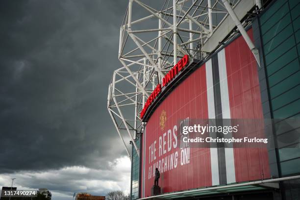 Heavy clouds linger as police and security staff stand guard outside Old Trafford Stadium ahead of the the Manchester United v Leicester City game on...
