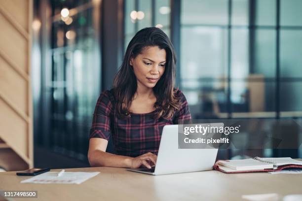 young black businesswoman working in the office - marketing research stock pictures, royalty-free photos & images