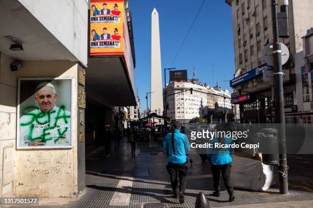 Sign with a photo of Pope Francis is displayed on Corrientes Avenue with a painted graffiti that reads in Spanish "it will be Law", in reference to...