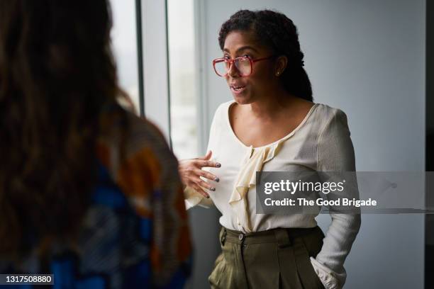 female colleagues having discussion in conference room - real people serious not looking at camera not skiny stock pictures, royalty-free photos & images