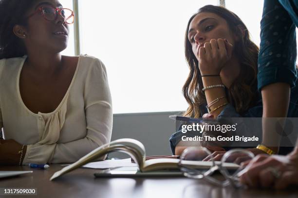 businesswomen having discussion in conference room - boring meeting stock pictures, royalty-free photos & images