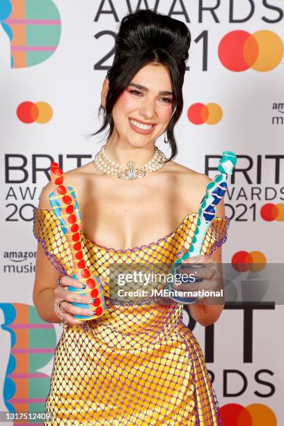 Dua Lipa poses in the media room with the Mastercard Album award for Future Nostalgia and the Female Solo Artist award during The BRIT Awards 2021 at...