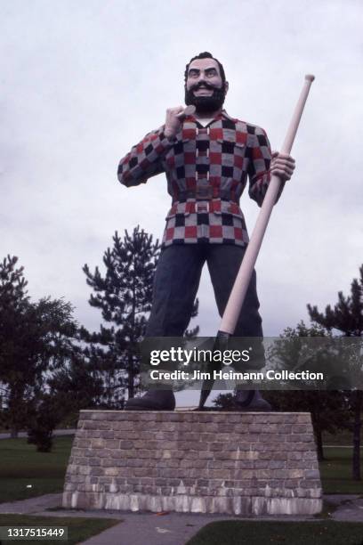 35mm film photo shows a 31-foot tall Paul Bunyan statue in Bangor, Maine, which is a landmark of the lumber industry and the famous lumberjack's...