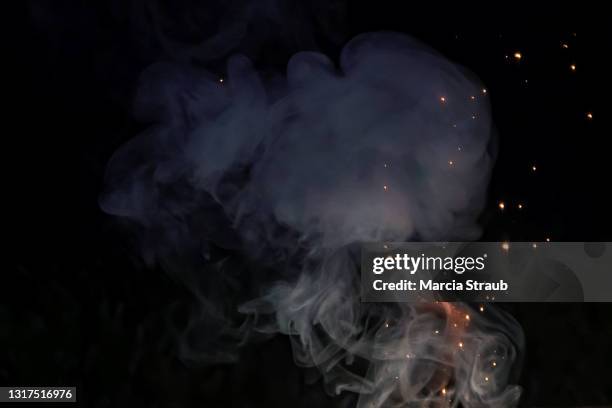 close up of abstract smoke swirling  against a black background - sparks fly stock pictures, royalty-free photos & images