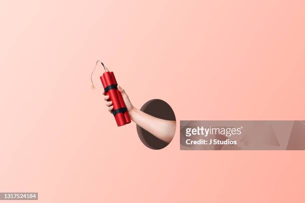 hand holding a bundle of dynamite - [object object] stock pictures, royalty-free photos & images