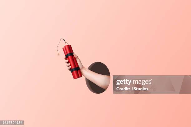 hand holding a bundle of dynamite - 2021 a funny thing stock pictures, royalty-free photos & images