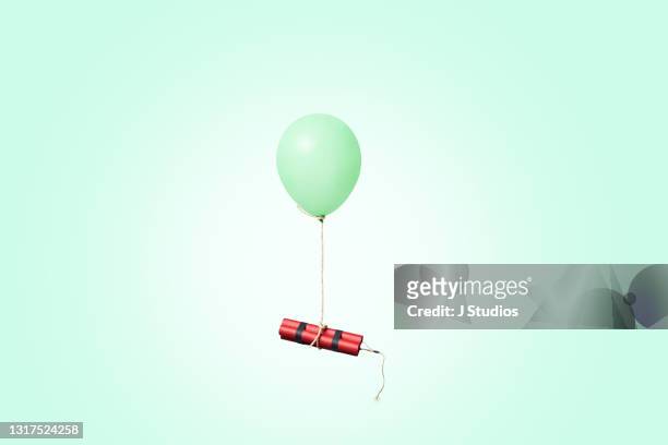 bundle of dynamite sticks tied to a balloon - lustig bunt bildbanksfoton och bilder