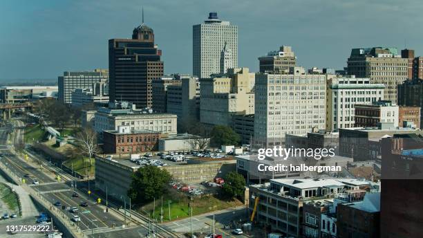 riverside drive and railroad tracks passing office buildings in downtown memphis - aerial - memphis tennessee stock pictures, royalty-free photos & images