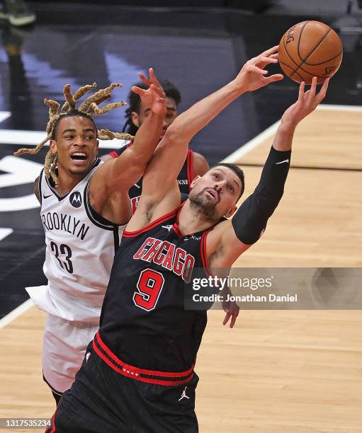 Nikola Vucevic of the Chicago Bulls rebounds against Nicolas Claxton of the Brooklyn Nets at the United Center on May 11, 2021 in Chicago, Illinois....