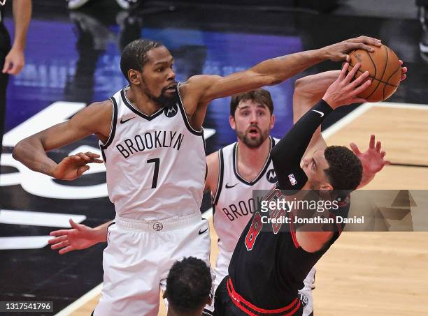 Kevin Durant of the Brooklyn Nets fouls Zach LaVine of the Chicago Bulls as he blocks his shot at the United Center on May 11, 2021 in Chicago,...