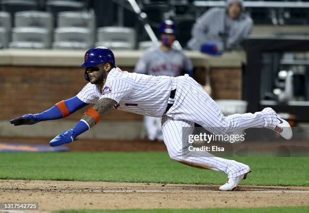 Jonathan Villar of the New York Mets scores the game winning run in the bottom of the ninth against the Baltimore Orioles at Citi Field on May 11,...