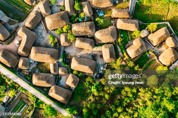 aerial view of old village in a fortress - rieten dak stockfoto's en -beelden
