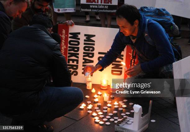 Supporters of the newly-formed Federation of Aotearoa Migrants hold a candlelit vigil and rally in Aotea Square on May 12, 2021 in Auckland, New...