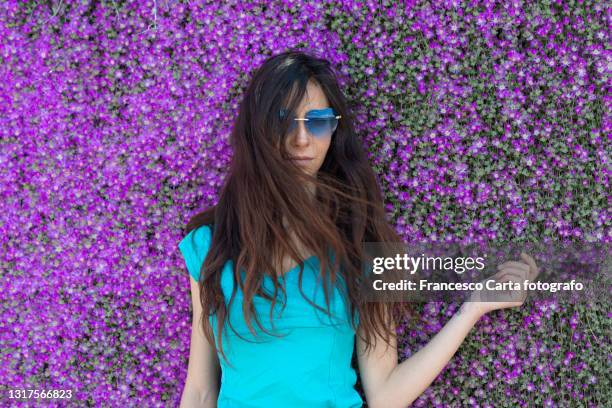 woman standing in front of delosperma flowers - magenta stock pictures, royalty-free photos & images