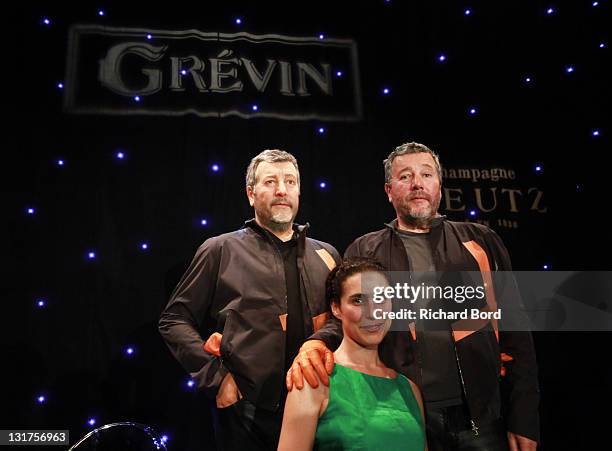 Jasmine Starck and Philippe Starck pose next to the Philippe Starck wax figure at Musee Grevin on June 15, 2010 in Paris, France.