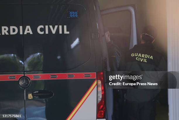 Guardia Civil officer takes Cesar Roman Viruete out of a police van to testify in a trial held at the Provincial Court of Madrid, on May 12, 2021 in...